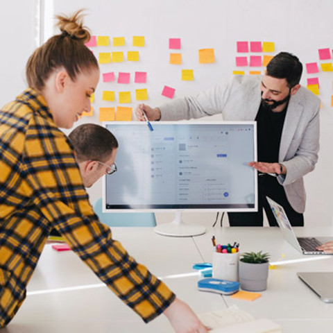 A group of people in a presentation meeting