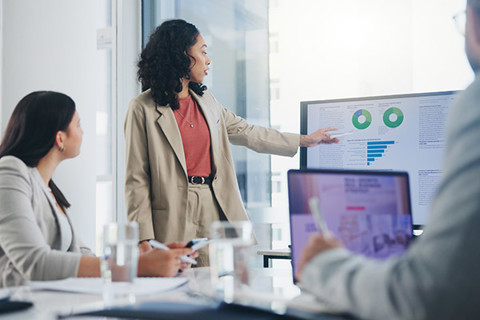 A woman presenting in a meeting