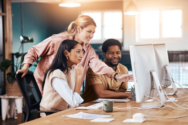 A group of people in a office computer workstation