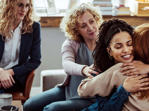 A group of women hugging each other