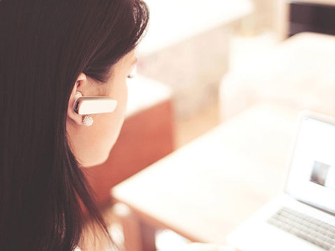 Woman browsing online with a hearing aid
