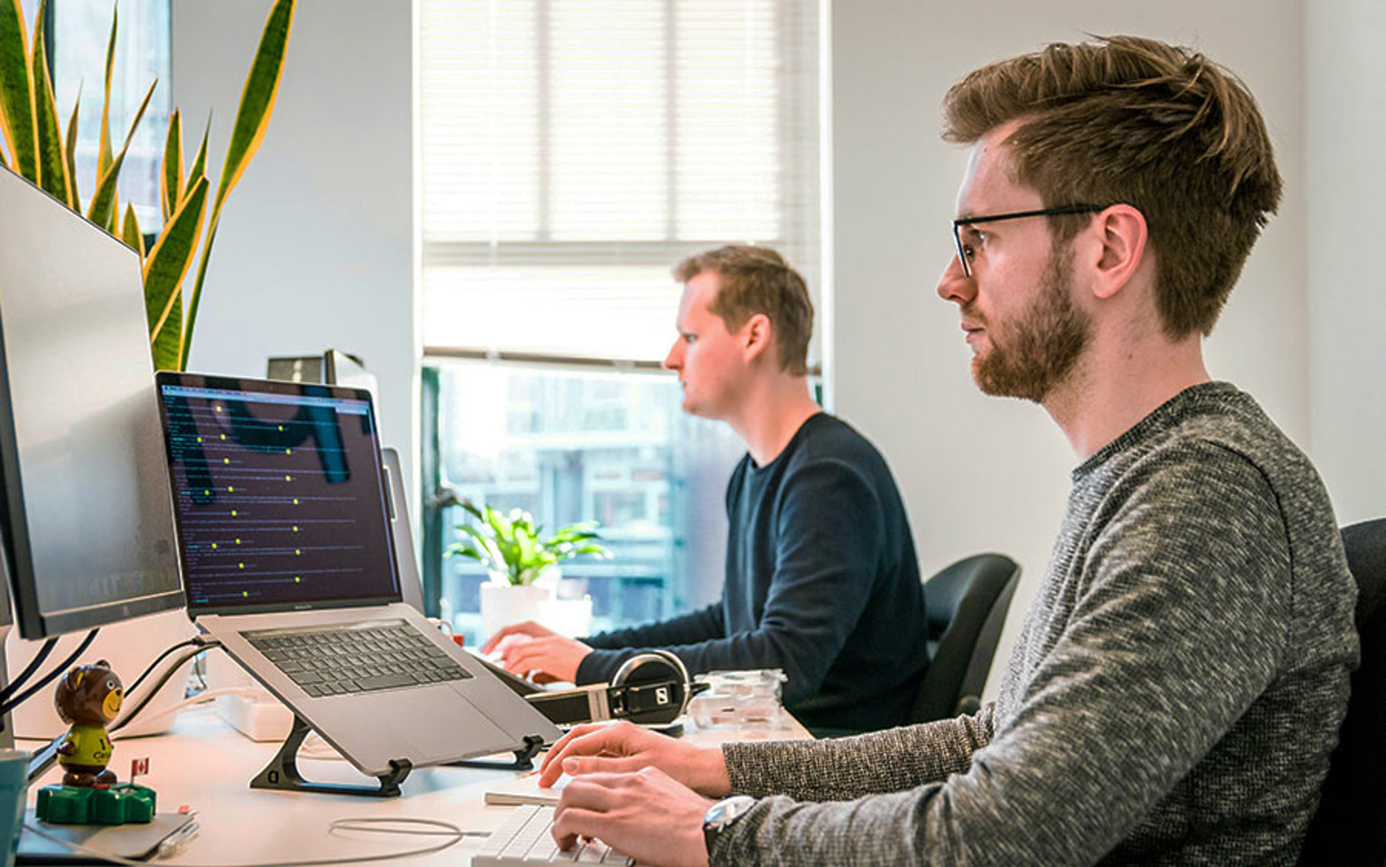 Two men working on computers
