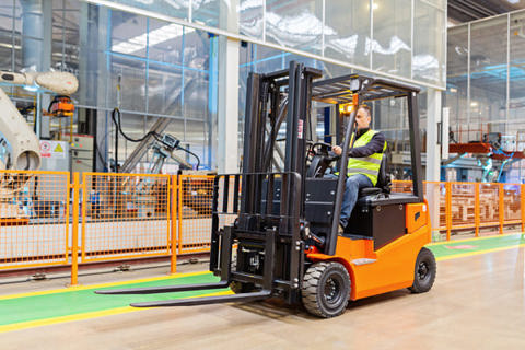 A person working with a forklift in a warehouse