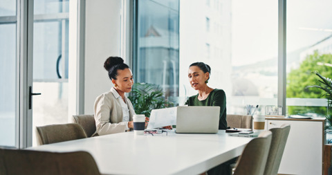Two women in a office meeting