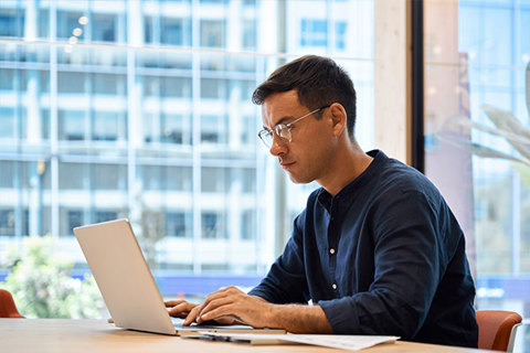A man typing on a laptop