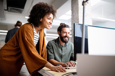 Two people at a office workstation