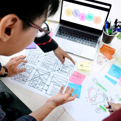 People looking at website wireframes
