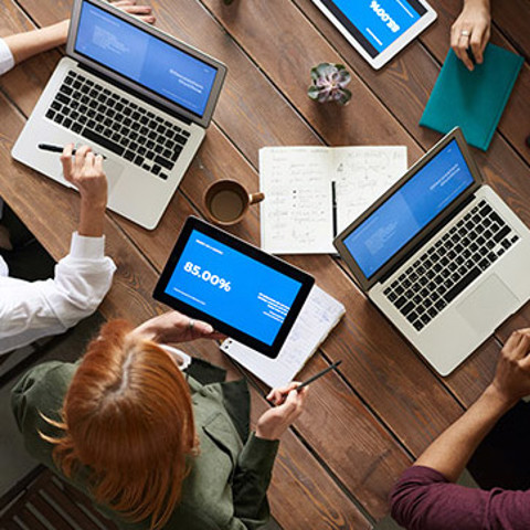 A group of people working on laptops