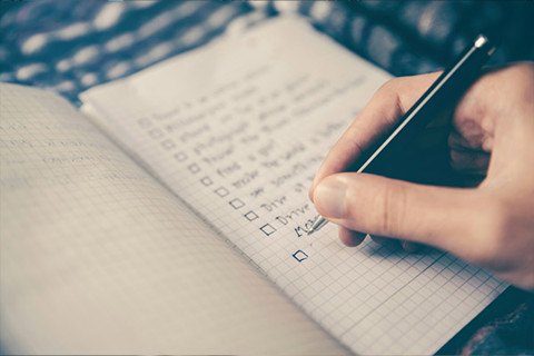A person writing out a checklist