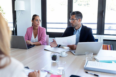 Three people in a meeting room