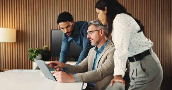 Three people in a office meeting