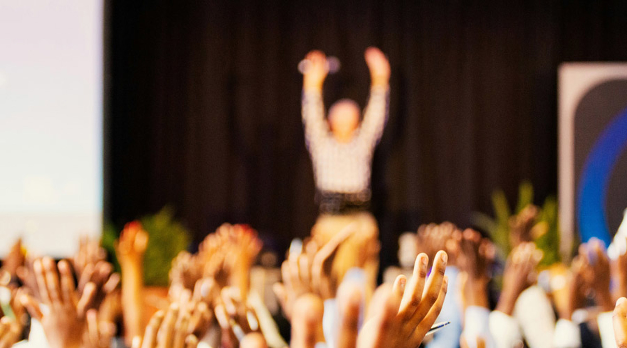 A group of school children with hands up
