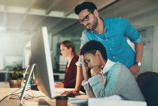 People at a office computer workstation
