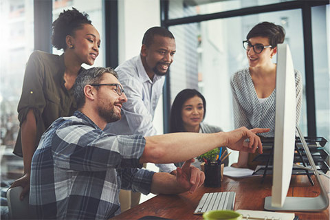 A group of people at a workstation